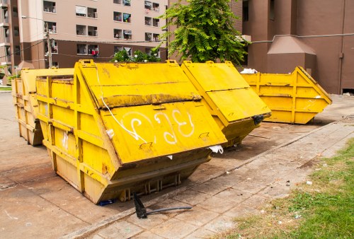 Commercial rubbish removal van parked on Aldgate street outside office buildings