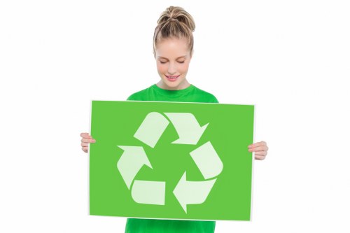 Photo of a worker assisting a customer with business waste containers at a commercial property
